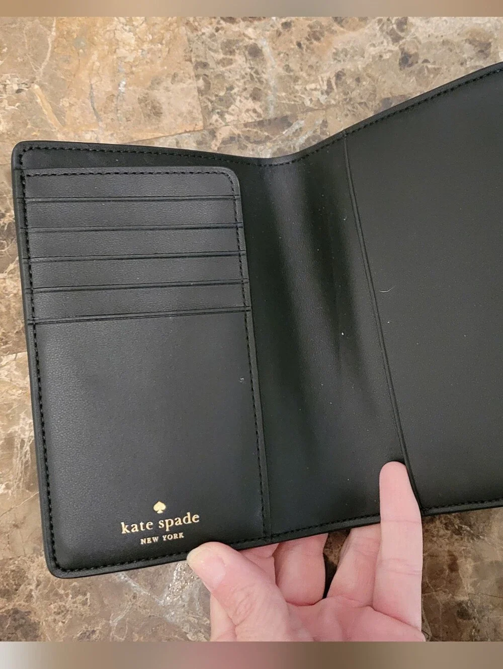 kate spade black saffiano passport wallet with gold logo